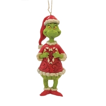 Grinch holding heart shaped candy